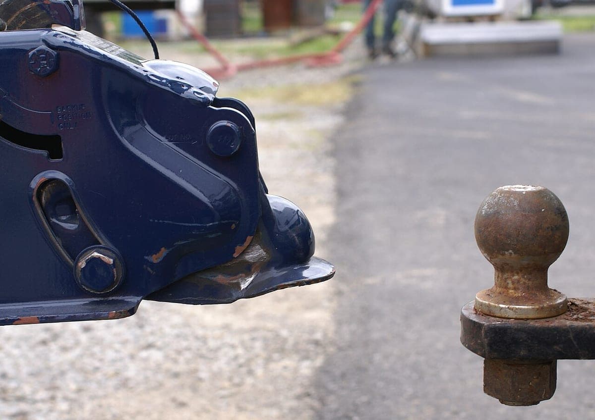 A trailer coupler seated on a hitch ball, photographed close up