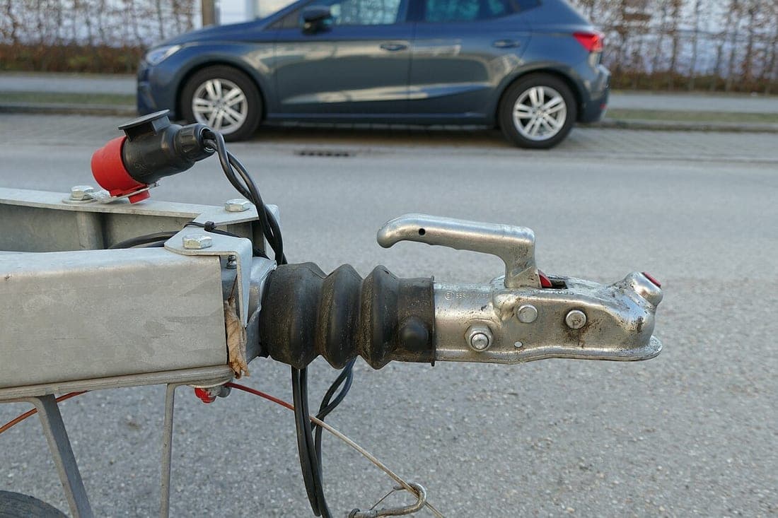A trailer coupler and tongue jack being connected to a vehicle
