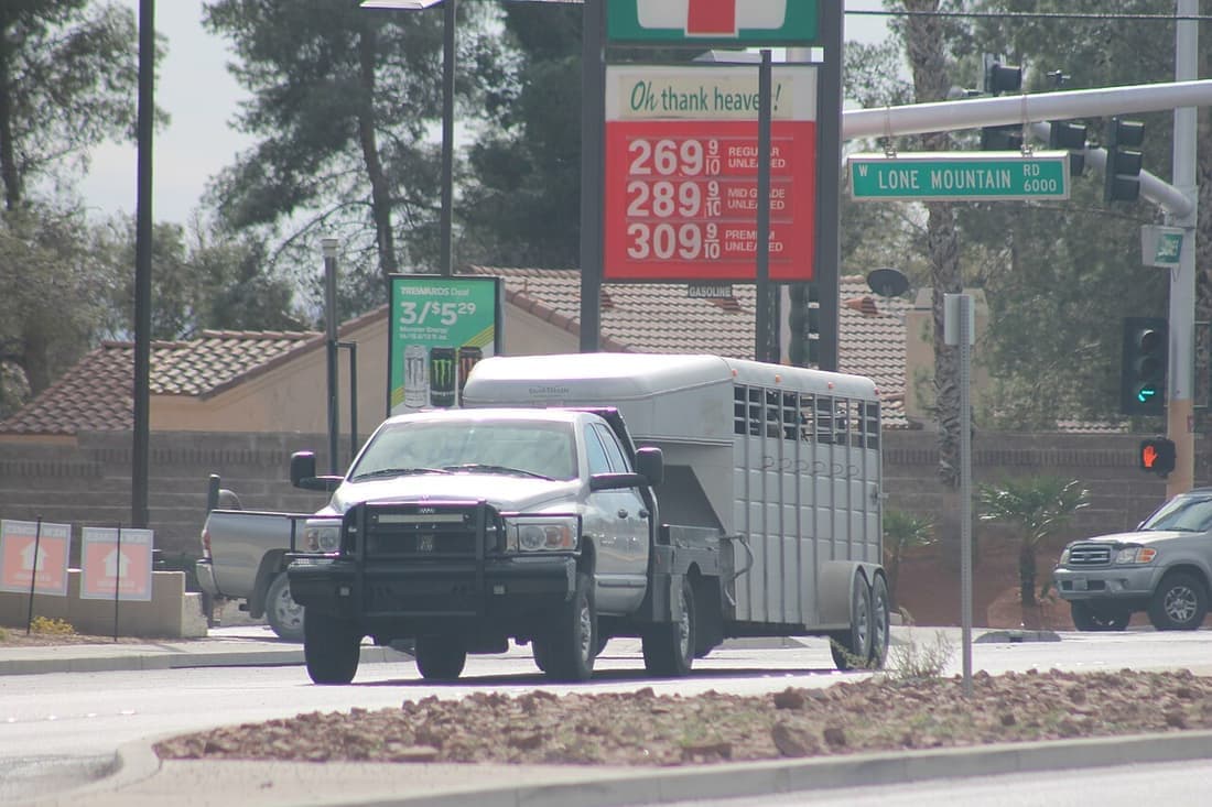 A heavy trailer being towed behind a full-size pickup truck