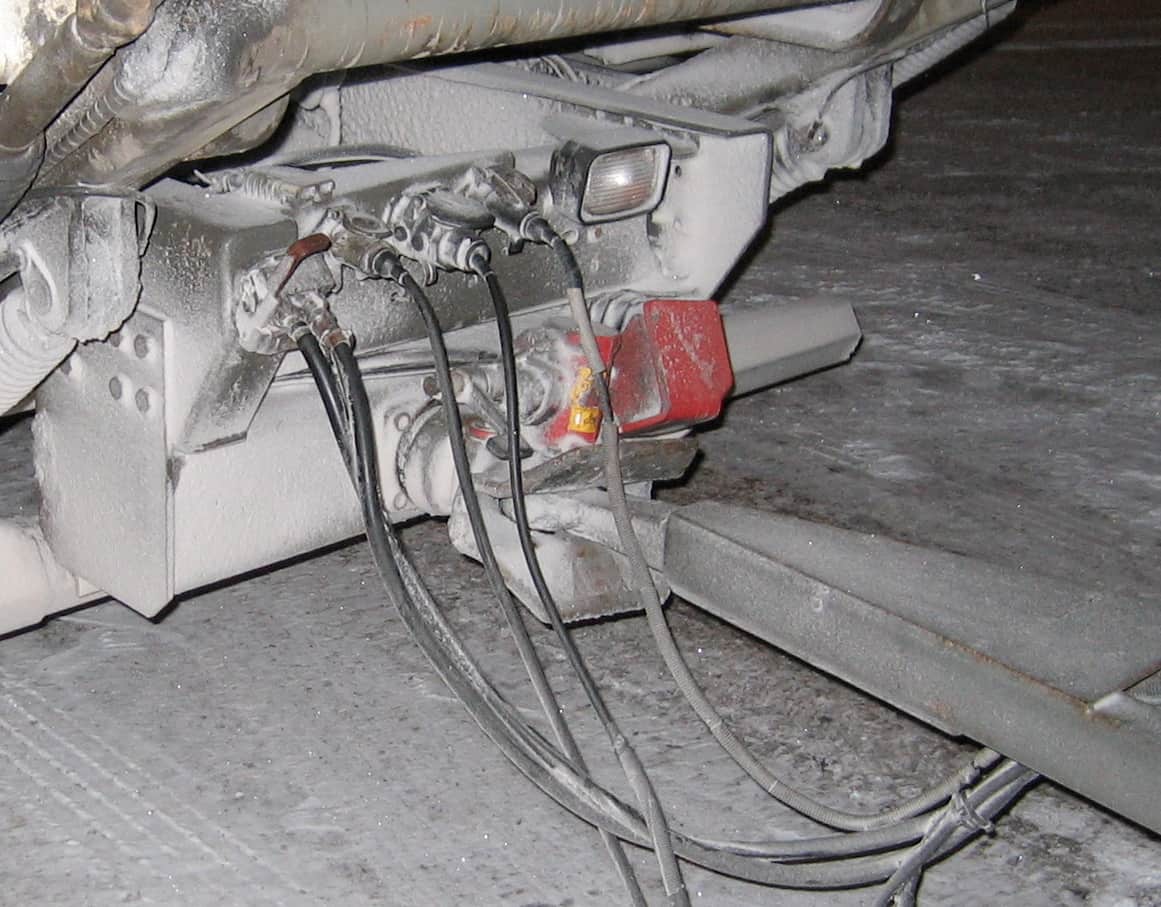 A drawbar coupling and wiring seen from beneath a trailer